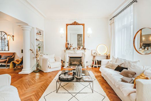 A cozy living room in Angers, France with a stylish fireplace and white furniture.